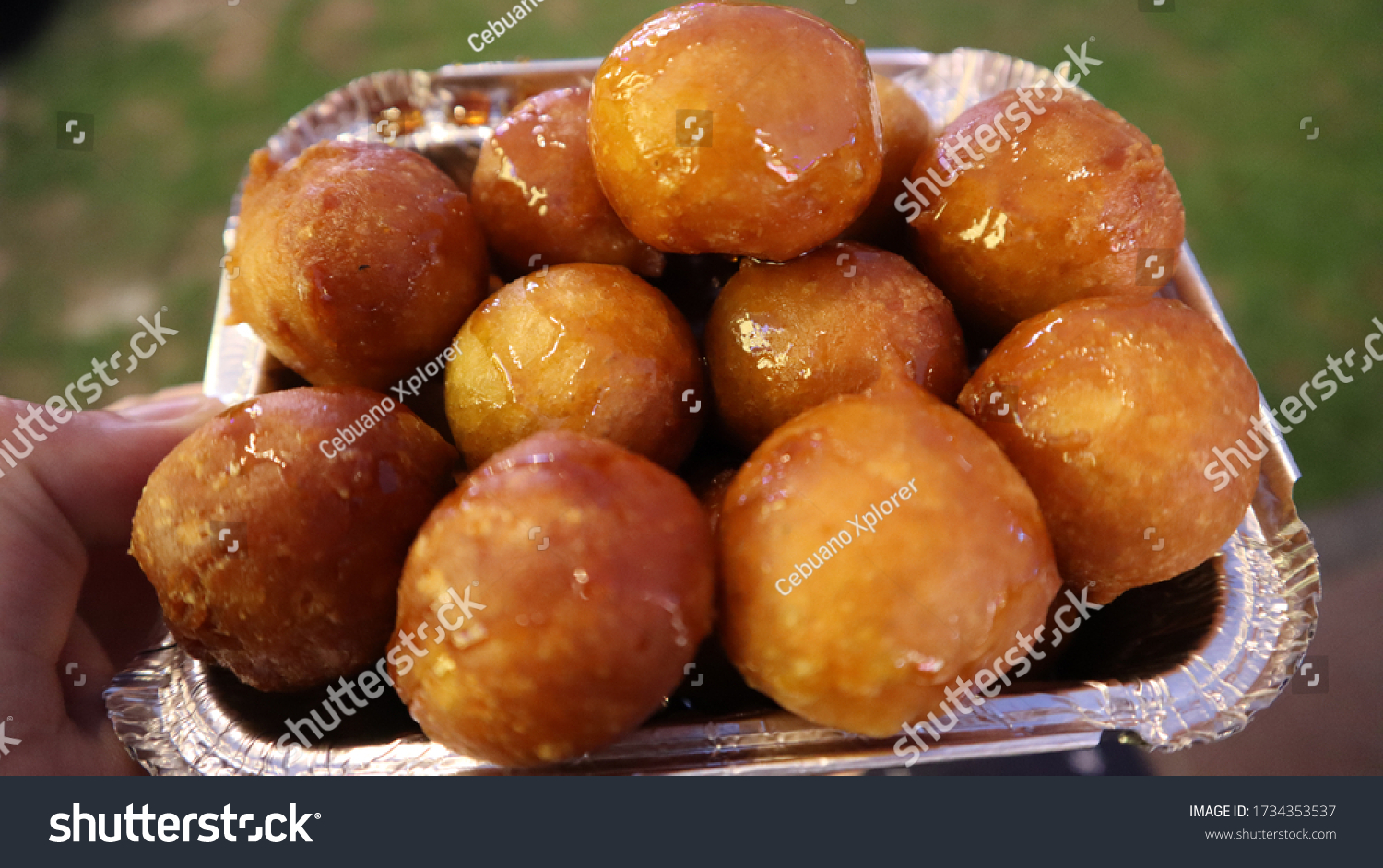 Small brown doughy balls coated with sugar syrup. This doughnut balls is famous sweets or dessert in United Arab Emirates particularly in Dubai. #1734353537