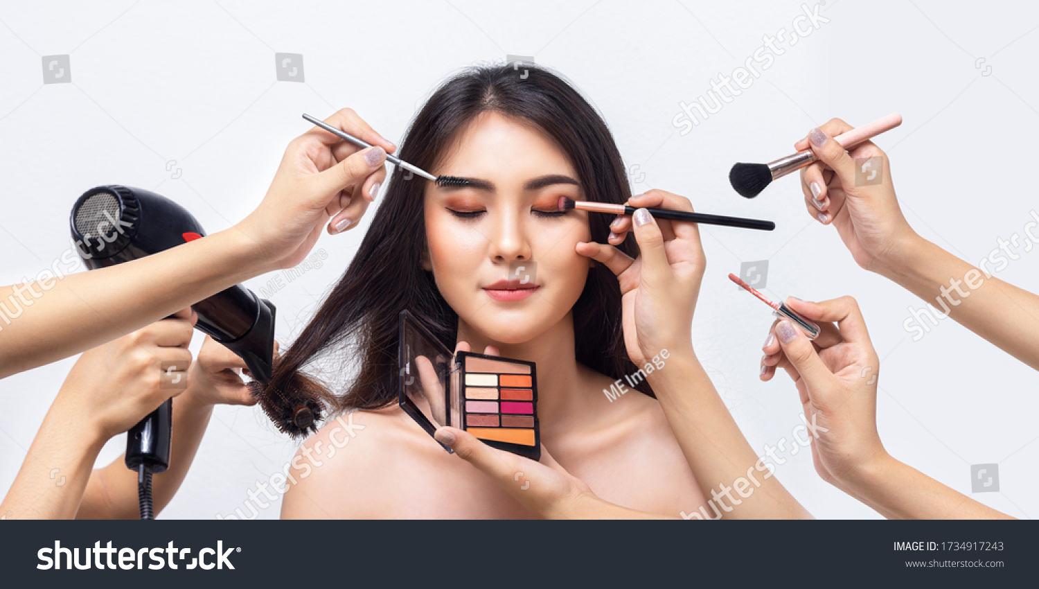 Beautiful Asian woman with many hand professional beautician makeup artists. Asian girl makeup by makeup artist team. Beauty of women. #1734917243