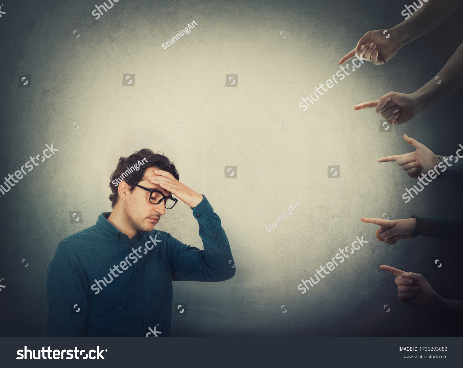 Exhausted businessman suffers dizziness, feels discomfort as multiple people hands pointing to him blaming as guilty. High tension and pressure, depression and emotional stress. Social victim concept. #1736293082