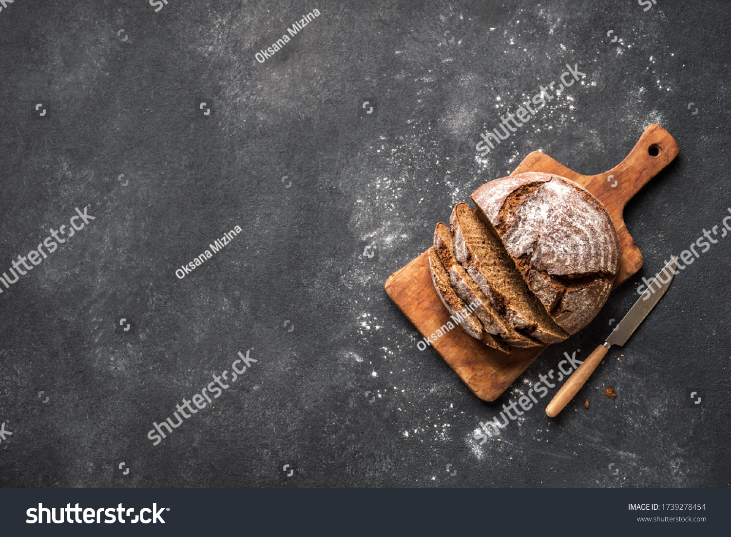Fresh Sourdough Bread  on black background. Fresh baked homemade sliced rye bread, top view, copy space. #1739278454