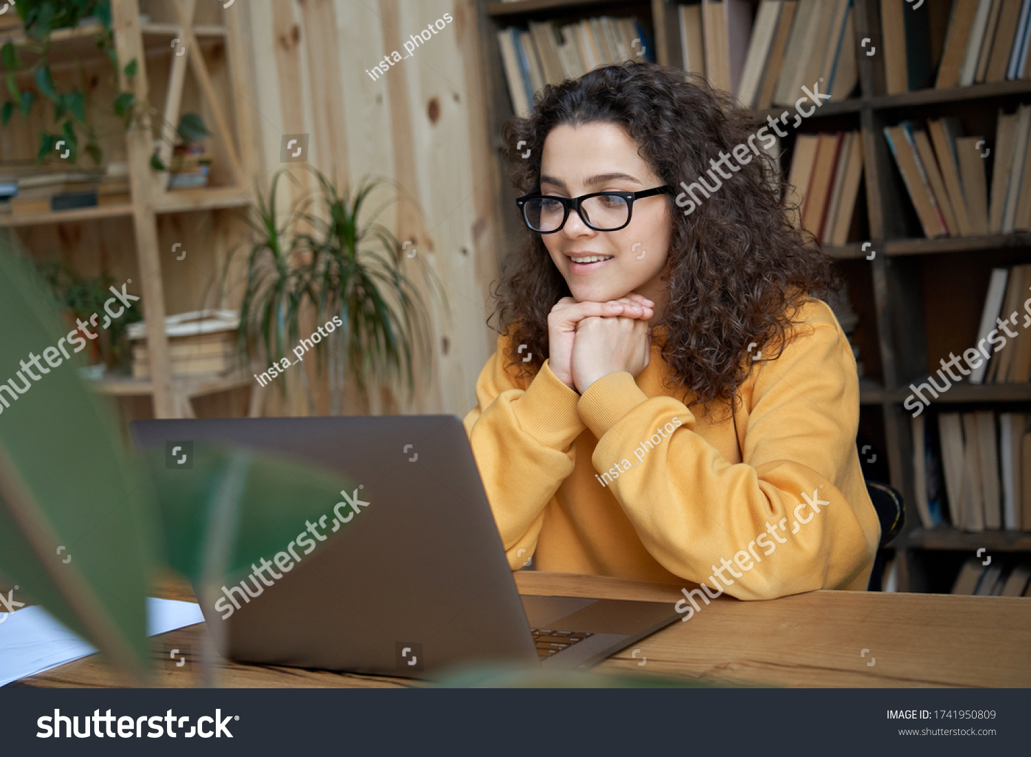Hispanic teen girl, latin young woman school student, remote worker learning watching online webinar webcast class looking at laptop elearning distance course or video calling remote teacher. #1741950809