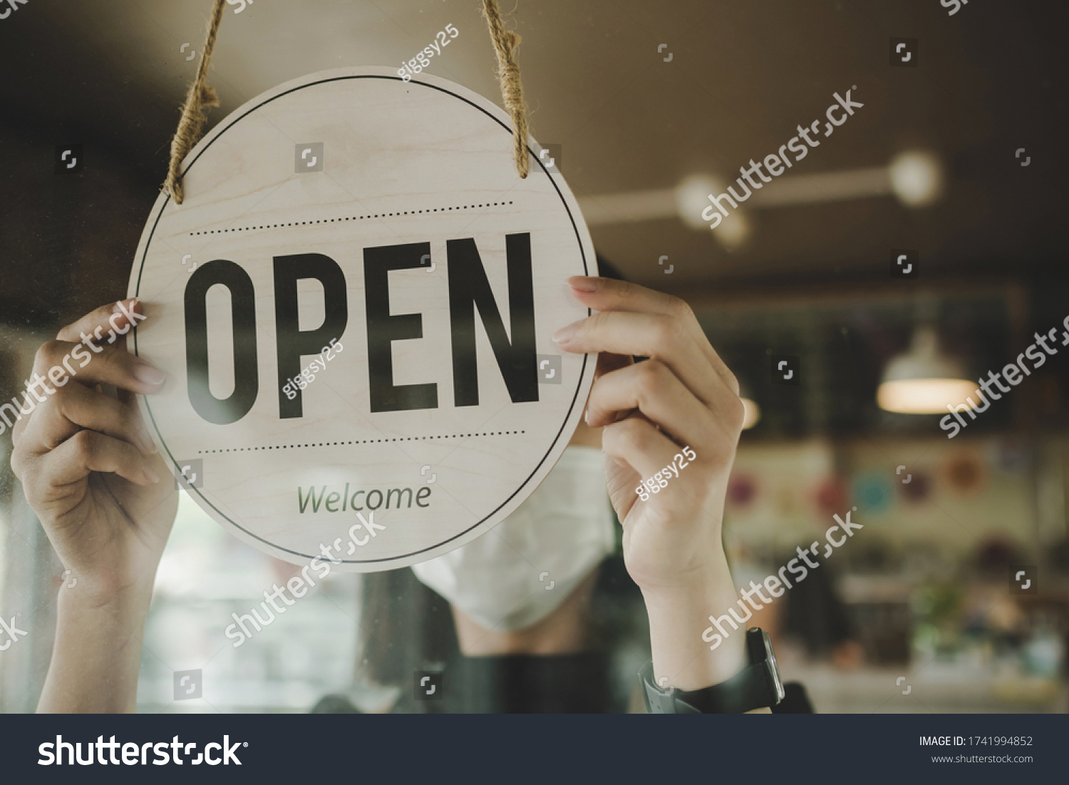 Open. barista, waitress woman wearing protection face mask turning open sign board on glass door in modern cafe coffee shop, cafe restaurant, retail store, small business owner, food and drink concept #1741994852