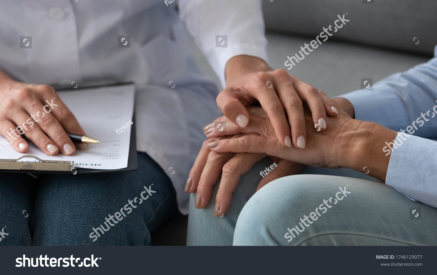 Seated on couch social service homecare nurse worker in white coat supports old patient hold hand encourages her close up, cancer diagnose, overcome illness, psychological help express empathy concept #1746129077