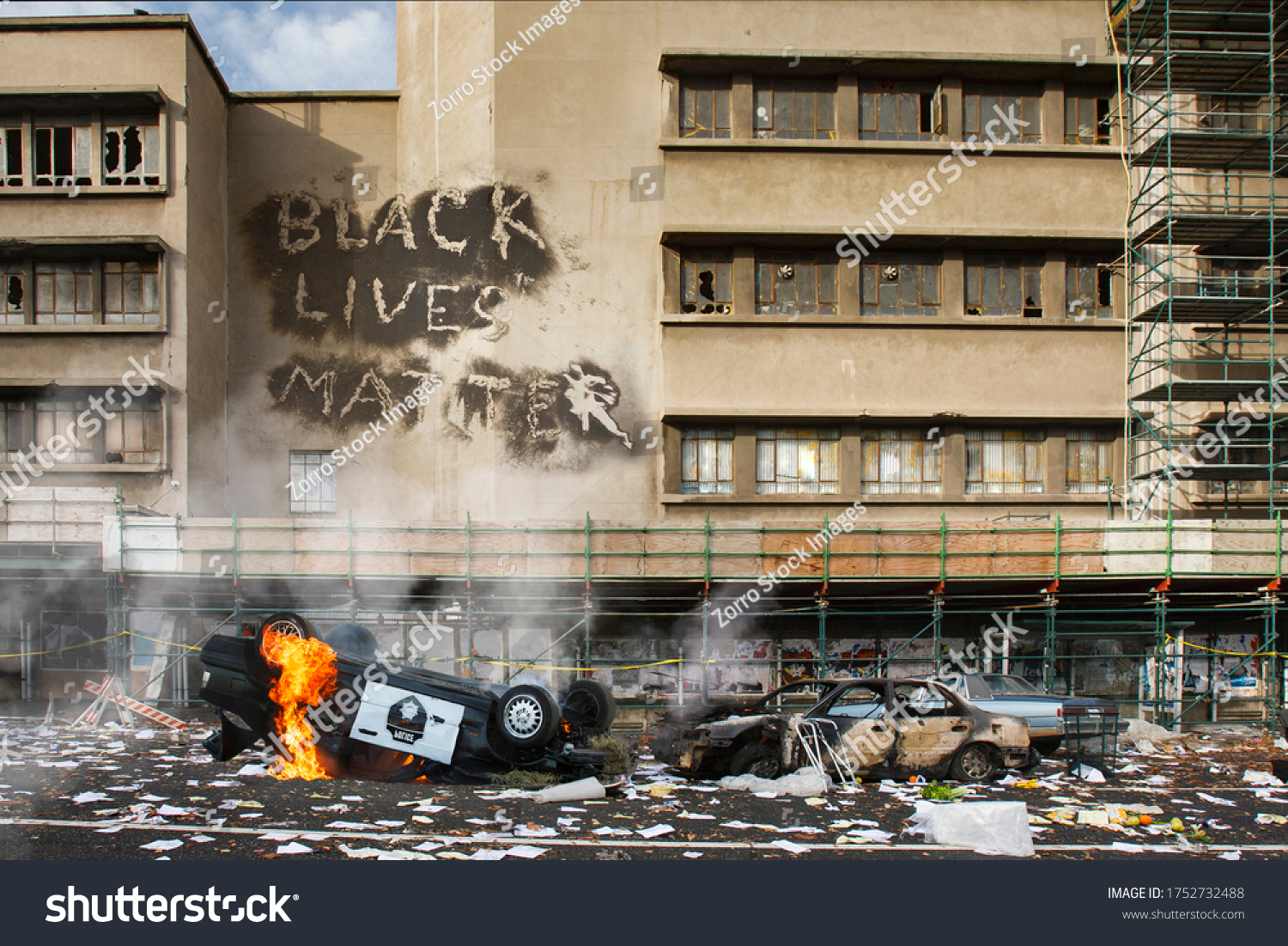 Black Lives Matter protest riot vandalism, looting aftermath concept, flaming police car smashed, overturned with black lives matter text slogan message on building. Excessive force, police brutality #1752732488