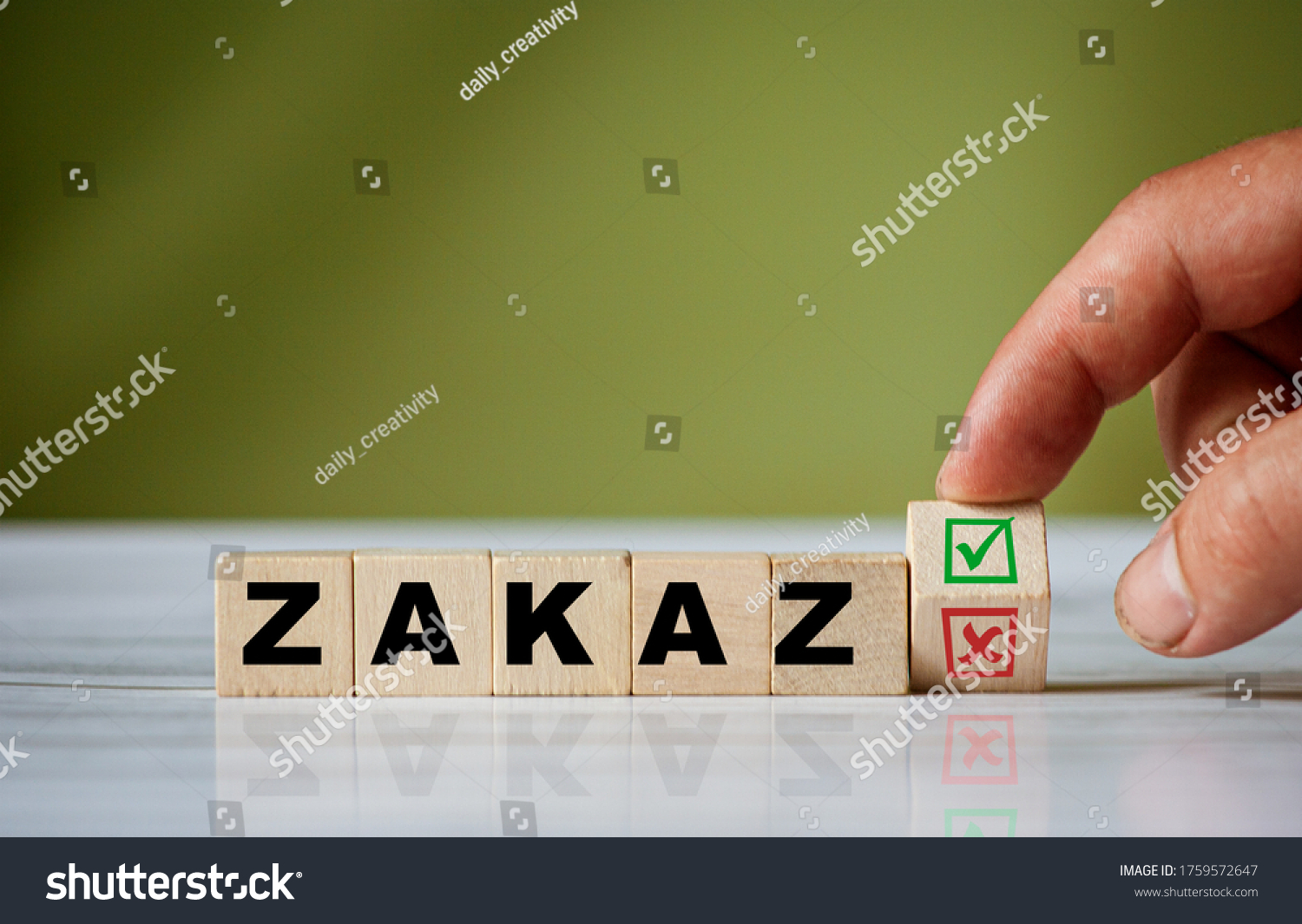 The hand turns the wooden cube and changes the polish word ZAKAZ (english = forbidden) with green positive tick check box and red reject X check box. #1759572647