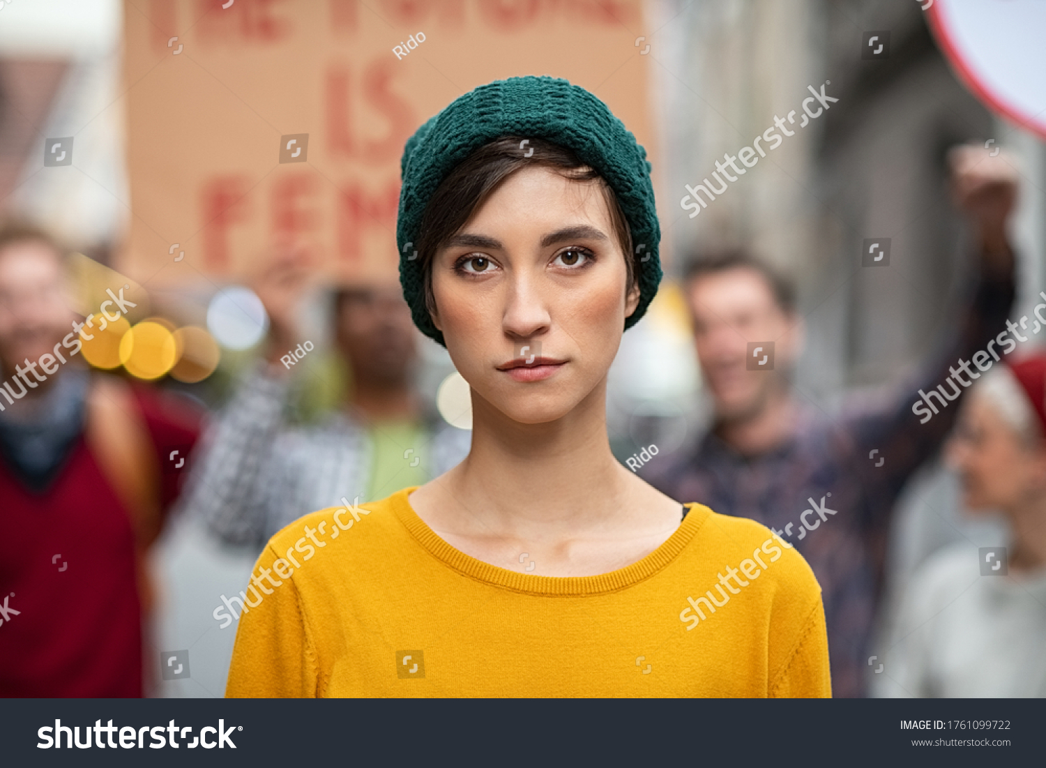 Portrait of confident woman in march fighting for freedom. Young latin woman empowerment strike on street. Casual girl in march to protest on equality rights. #1761099722