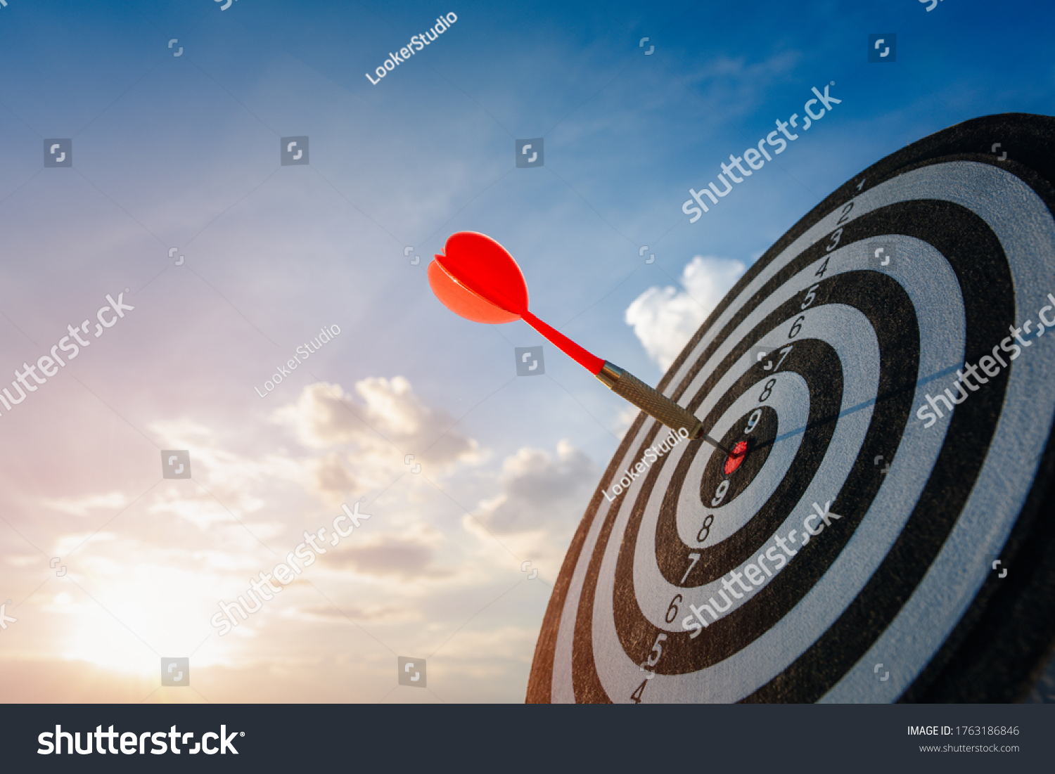 business marketing as concept. Red dart arrow hitting in the target center of dartboard Target hit in the center. #1763186846