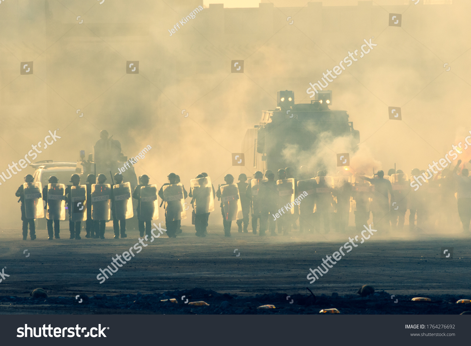 Military police riot response to a protest with tear gas, smoke, fire, explosions. Political expression, riot, protest, demostration and military concept. #1764276692