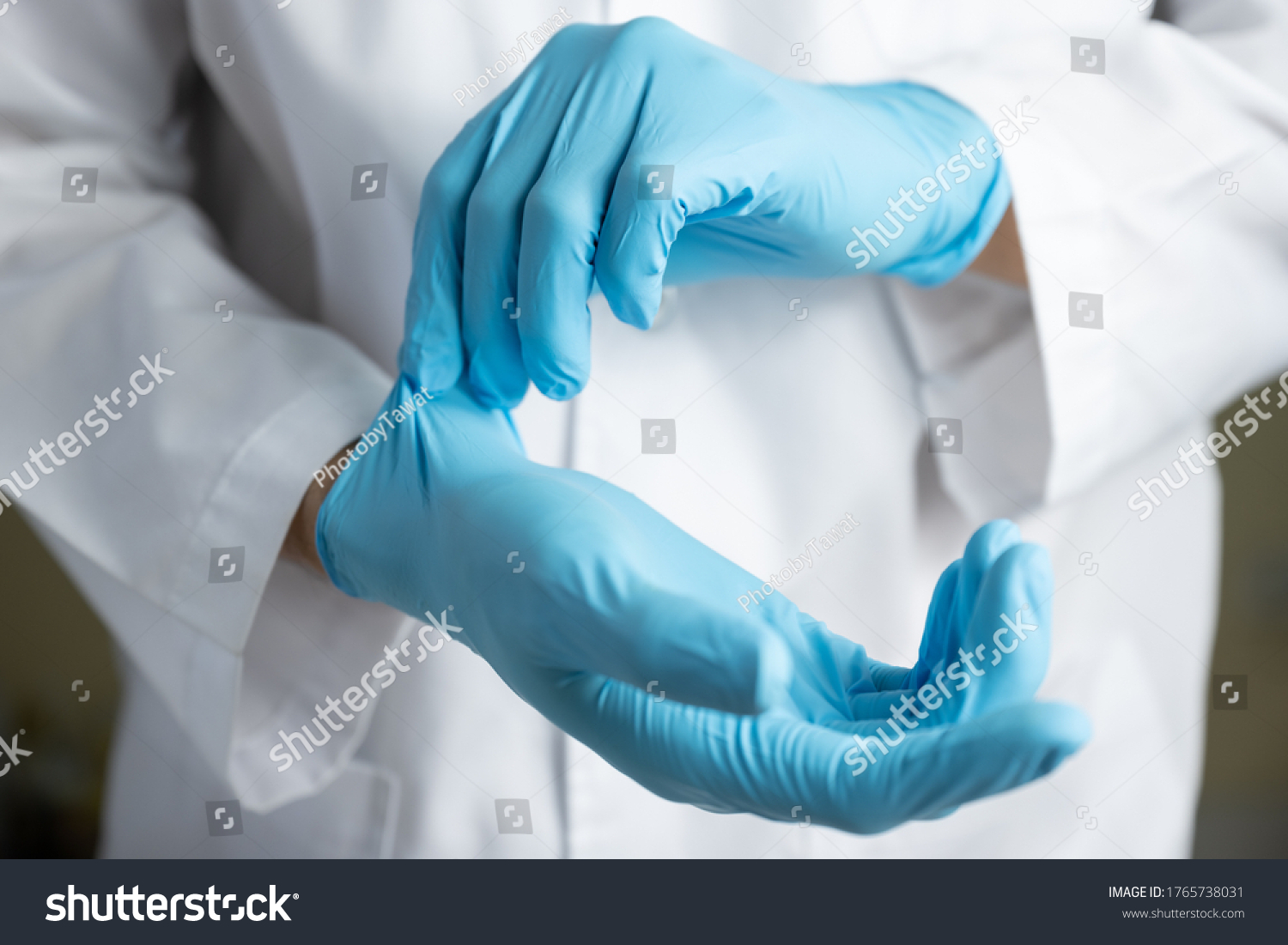 Doctor wearing blue nitrile gloves #1765738031