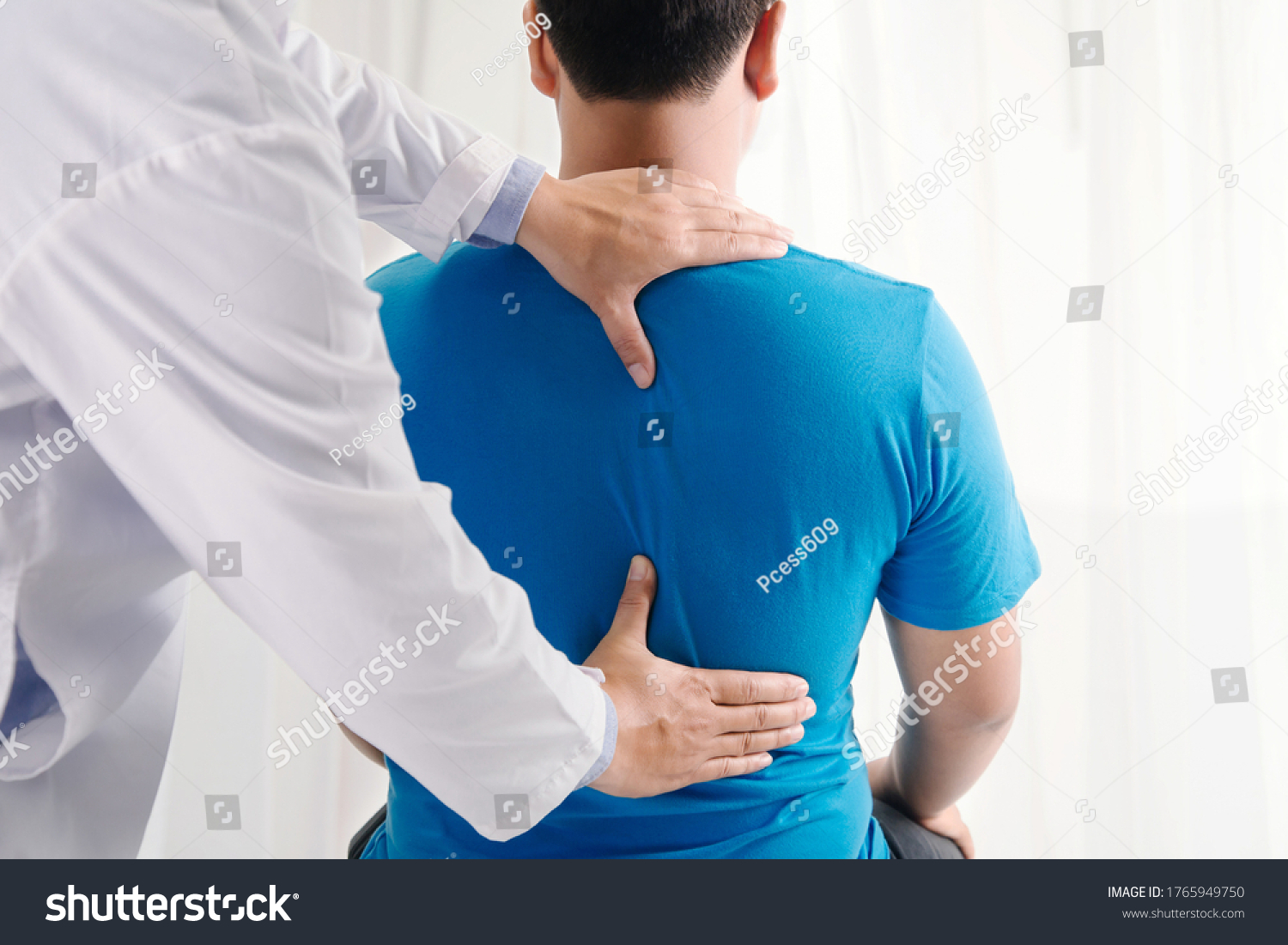 Doctor physiotherapist doing healing treatment on man's back.Back pain patient, treatment, medical doctor, massage therapist.office syndrome #1765949750