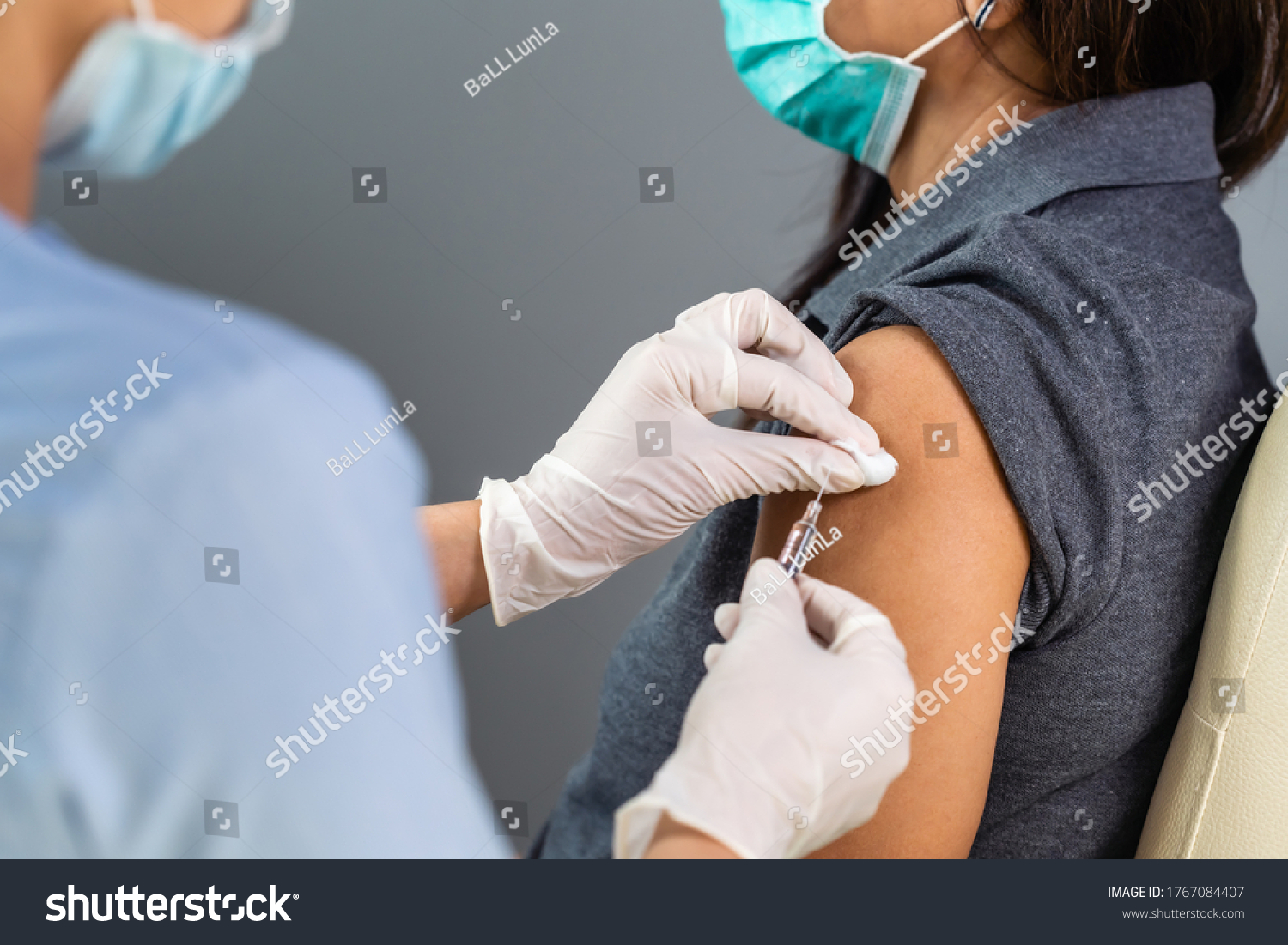 close up doctor holding syringe and using cotton before make injection to patient in medical mask. Covid-19 or coronavirus vaccine #1767084407