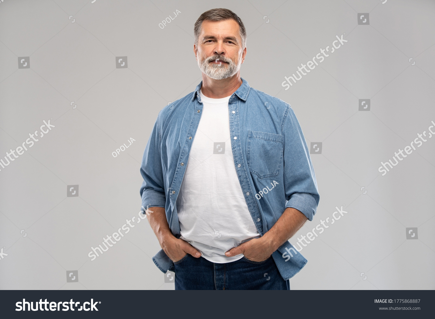 Portrait of smiling mature man standing on white background. #1775868887