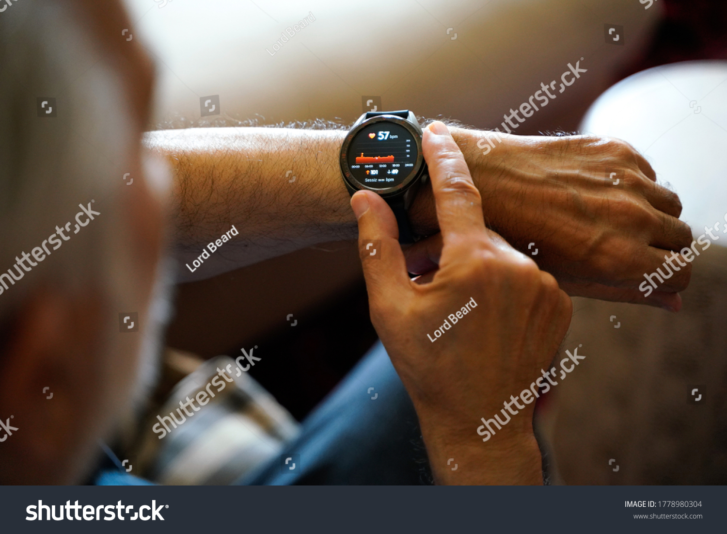 old white haired man using smart watch checking his cardiogram ecg #1778980304