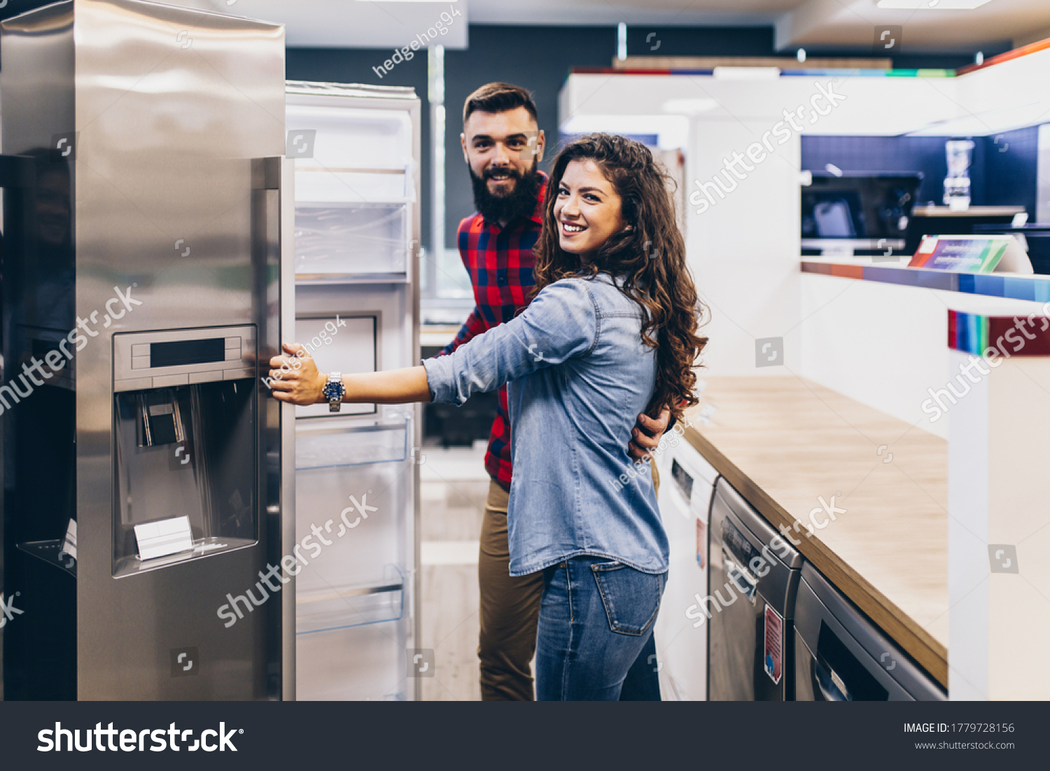 Young couple, satisfied customers choosing fridge in appliances store. #1779728156