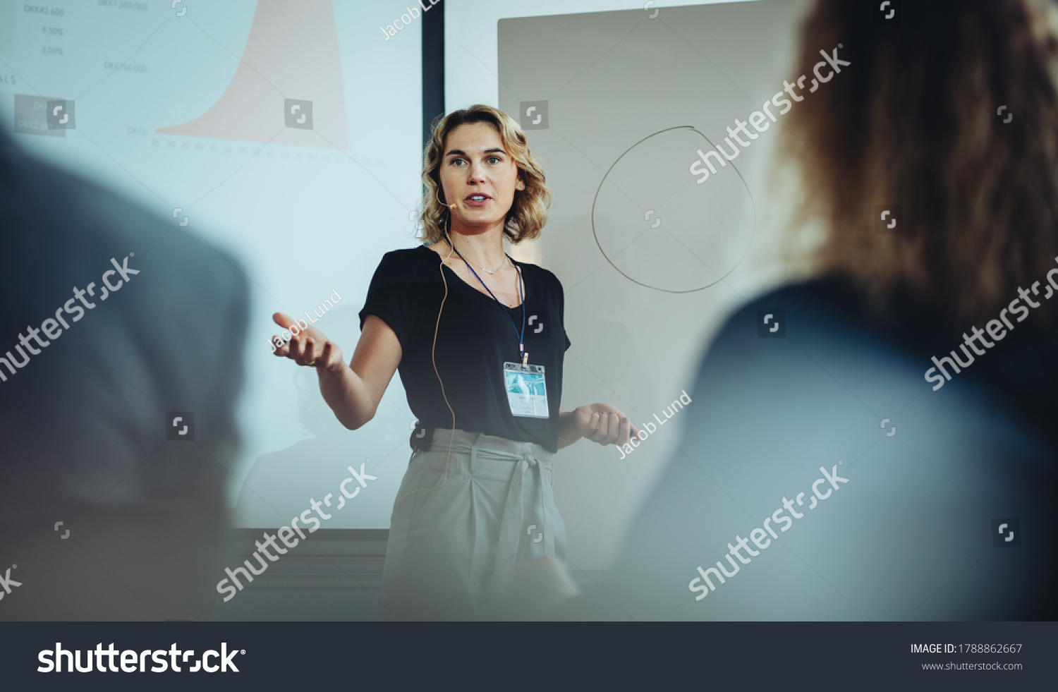 Woman presenting her idea to colleagues in meeting. Businesswoman public speaking in a conference meeting. #1788862667