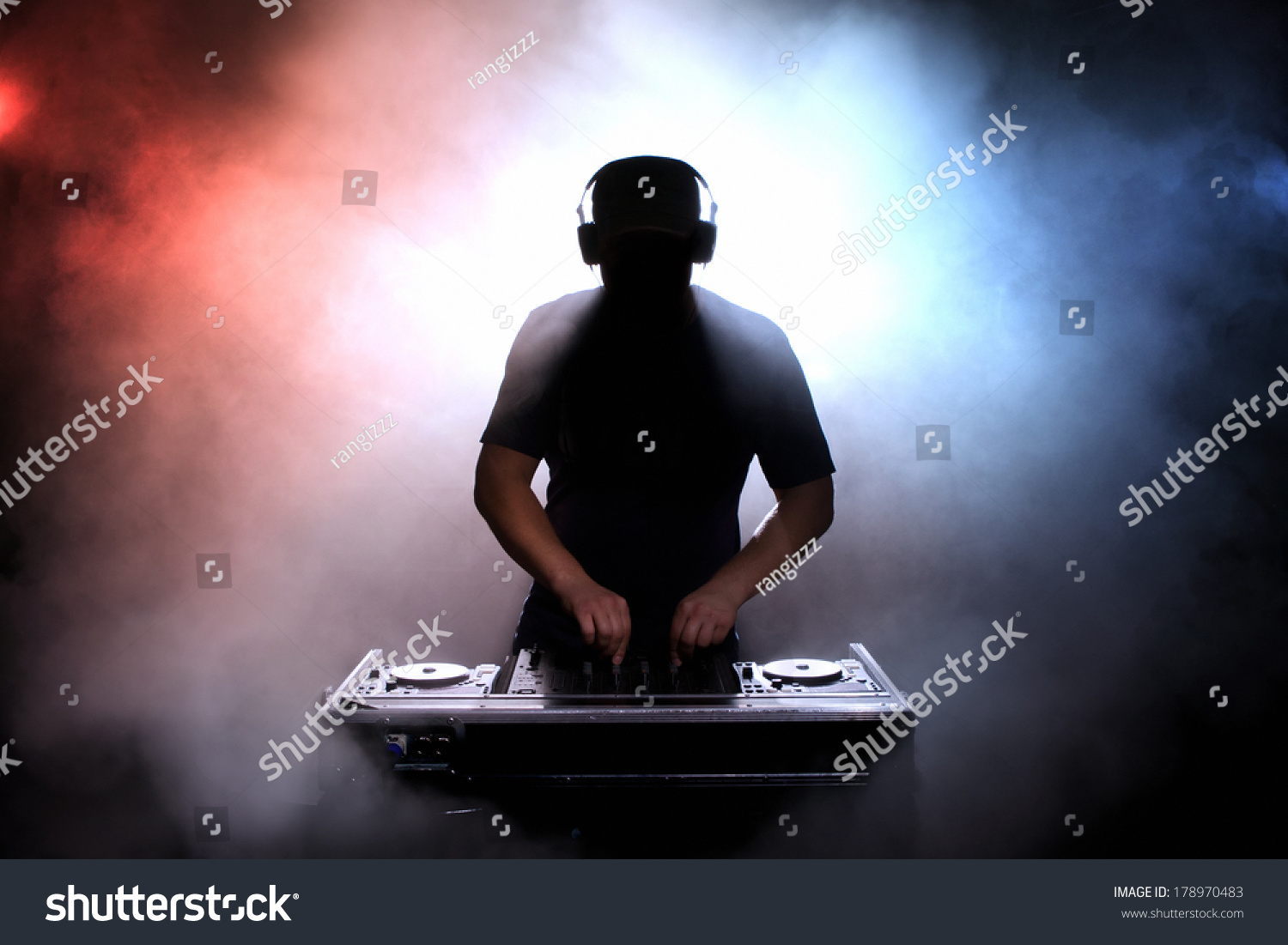 Disc jokey, DJ, silhouette over foggy illuminated background #178970483
