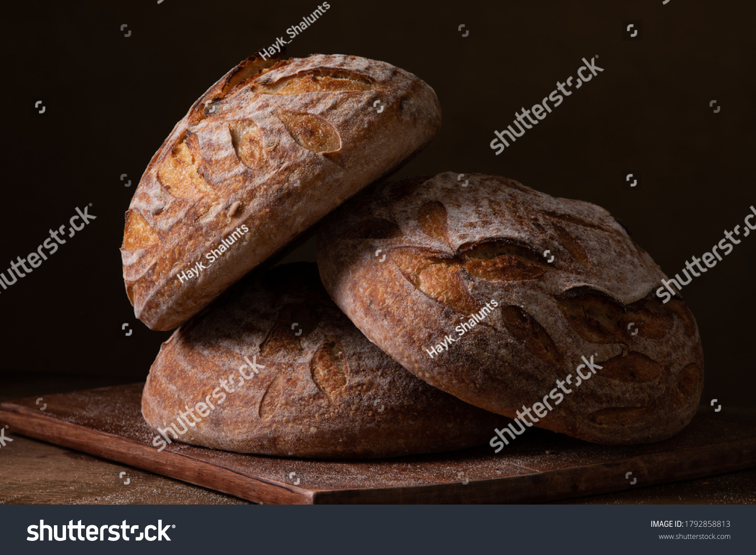 Freshly baked sourdough bread with floral decoration on it  #1792858813