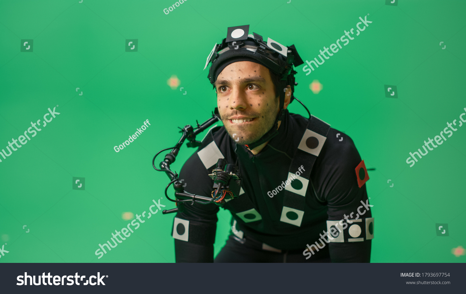 Actor Wearing Motion Caption Suit and Head Rig acts as an Animal or a Monster for CGI Green Screen Scene. Filmmaking On Film Studio Set Shooting Blockbuster Movie with Chroma Key. #1793697754