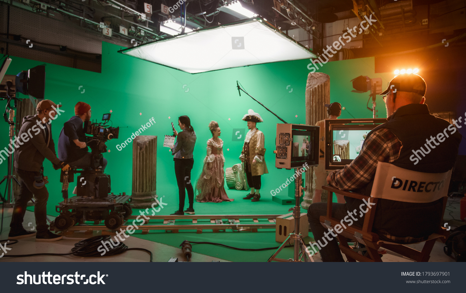 On Big Film Studio Professional Crew Shooting History Costume Drama Movie. On Set: Director Controls Cameraman Shooting Green Screen Scene with Two Actors Talented Wearing Renaissance Clothes Talking #1793697901