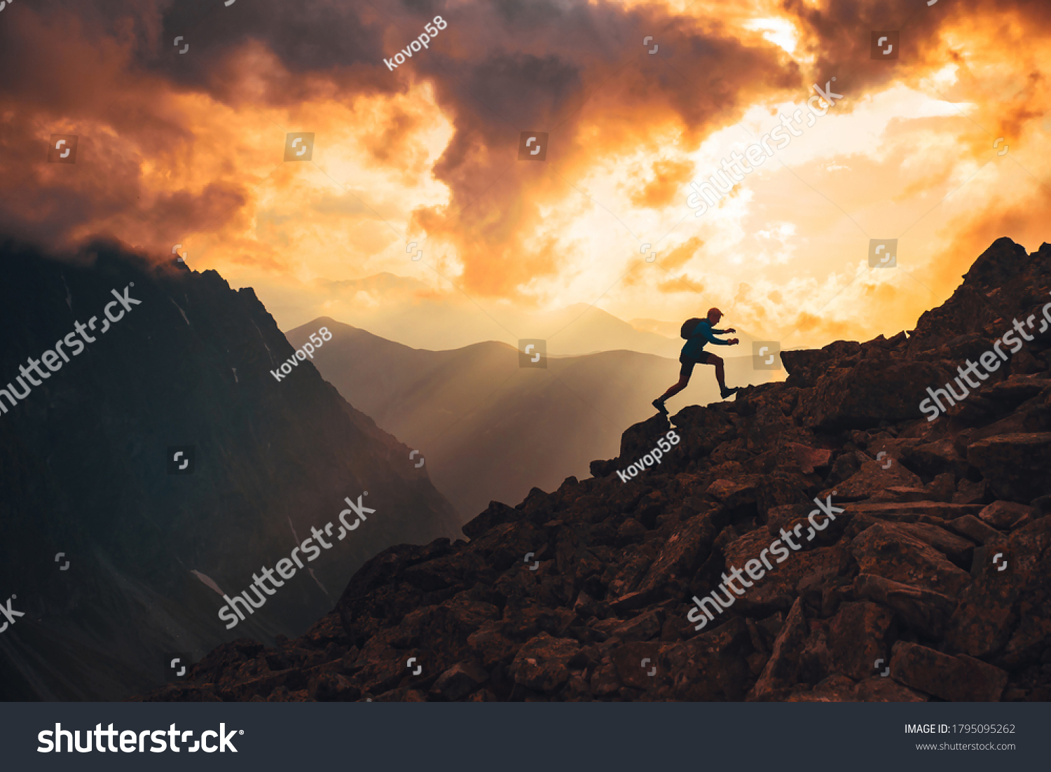 Active young man run on the top of the hill. Sunset mountains in background. Slovakia, High Tatras #1795095262