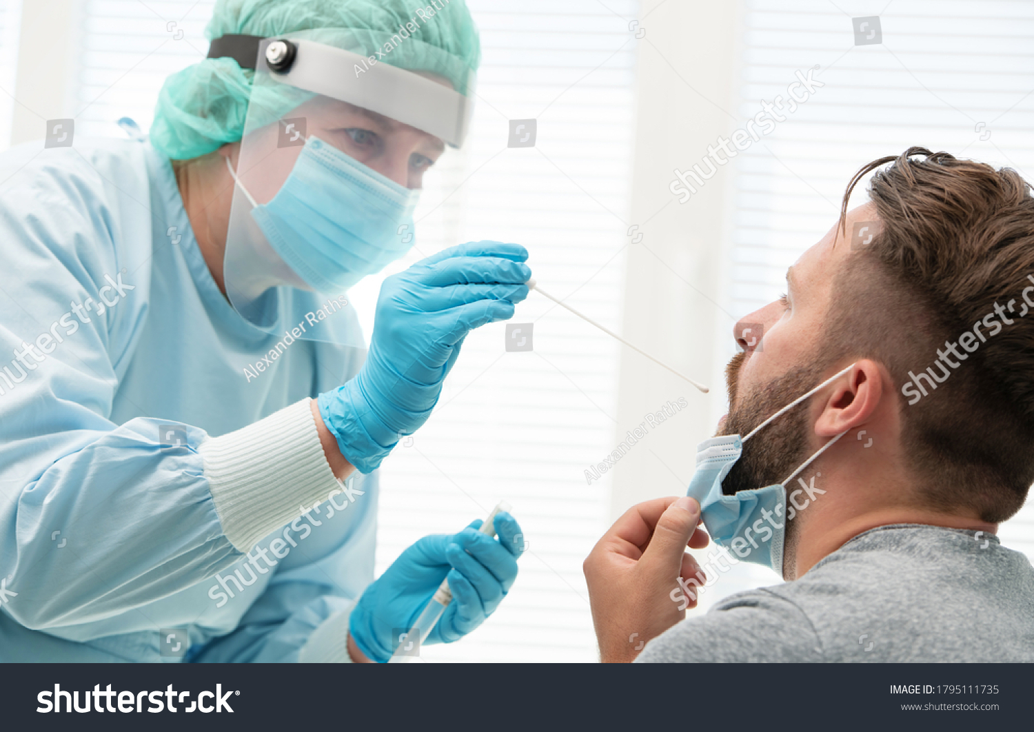 Doctor in a protective suit taking a throat and nasal swab from a patient to test for possible coronavirus infection #1795111735