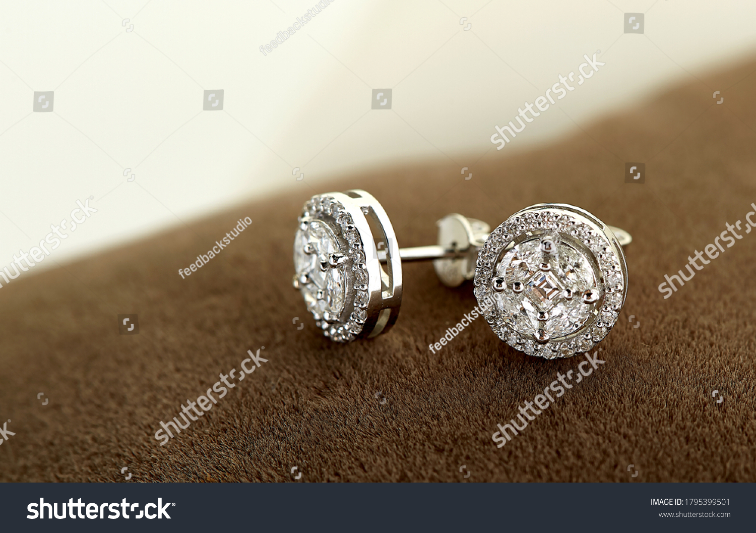 
Diamond jewelry. Diamond earrings on brown velvet #1795399501