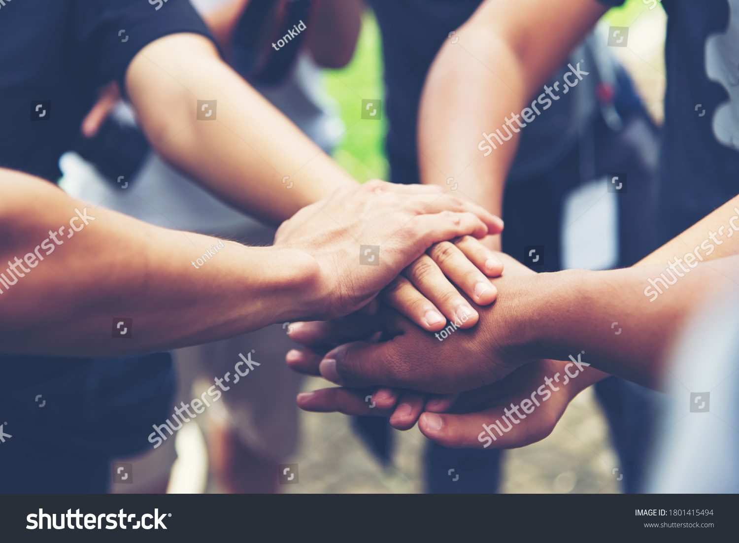 Solidarity unite people hands together community teamwork. Hands of spirit team working together outdoor. Unity strong handshake with people or agreement of feeling or happy diverse education action #1801415494