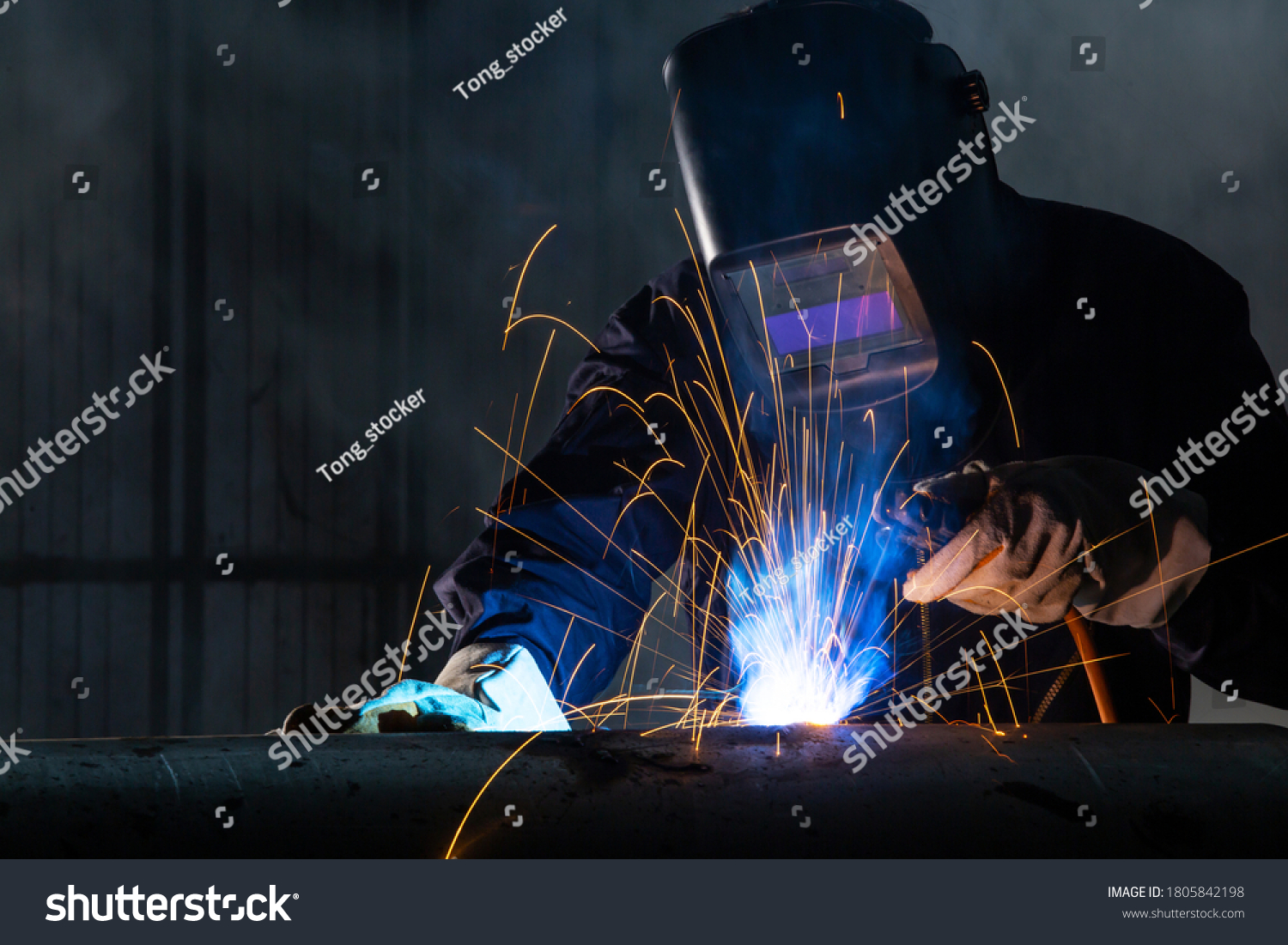 Asian workers wearing safety first uniforms and Welded Iron Mask at Steel welding plants, industrial safety first concept. #1805842198