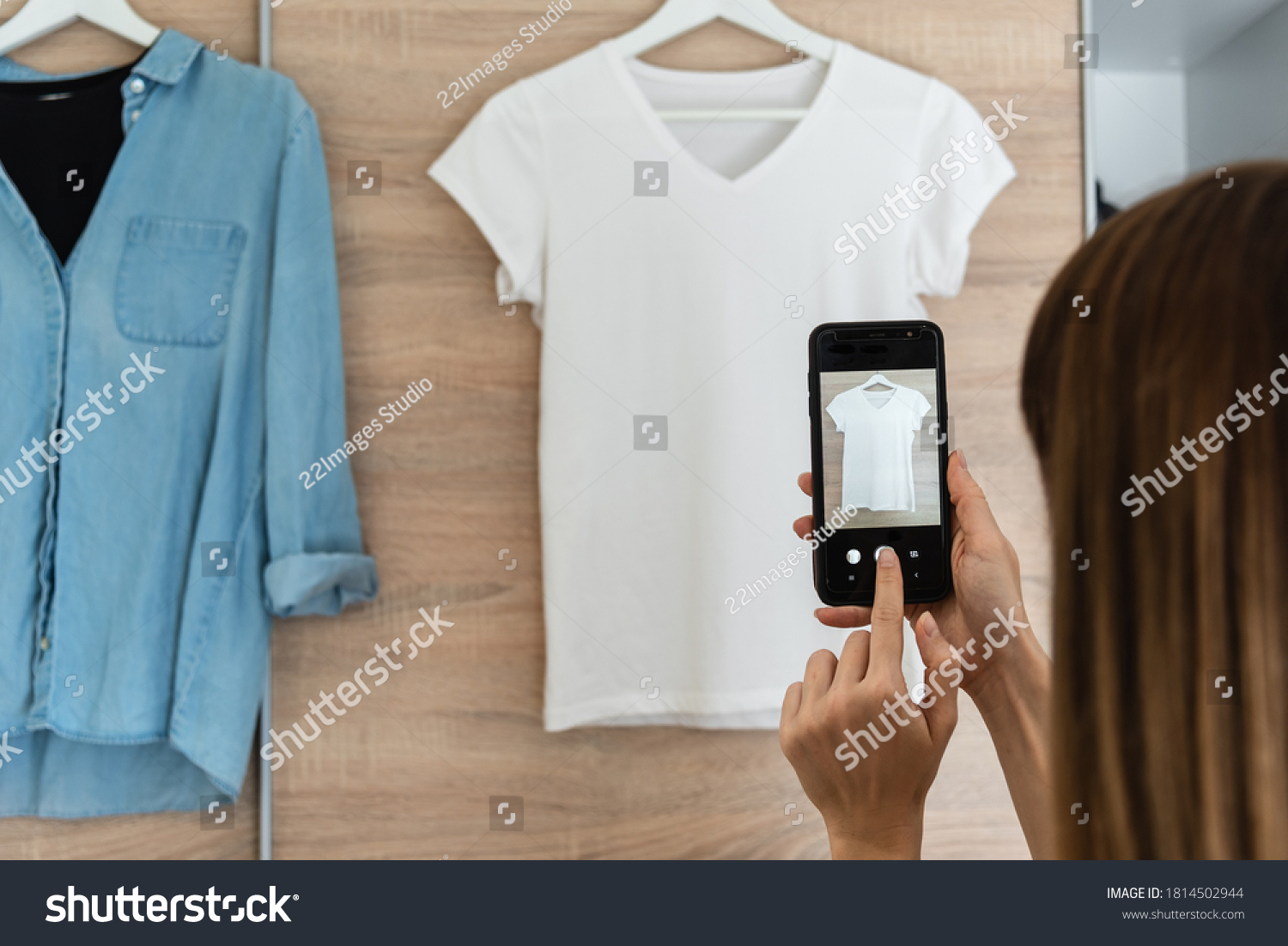 Woman taking picture of used clothes. Selling used clothes concept.  #1814502944