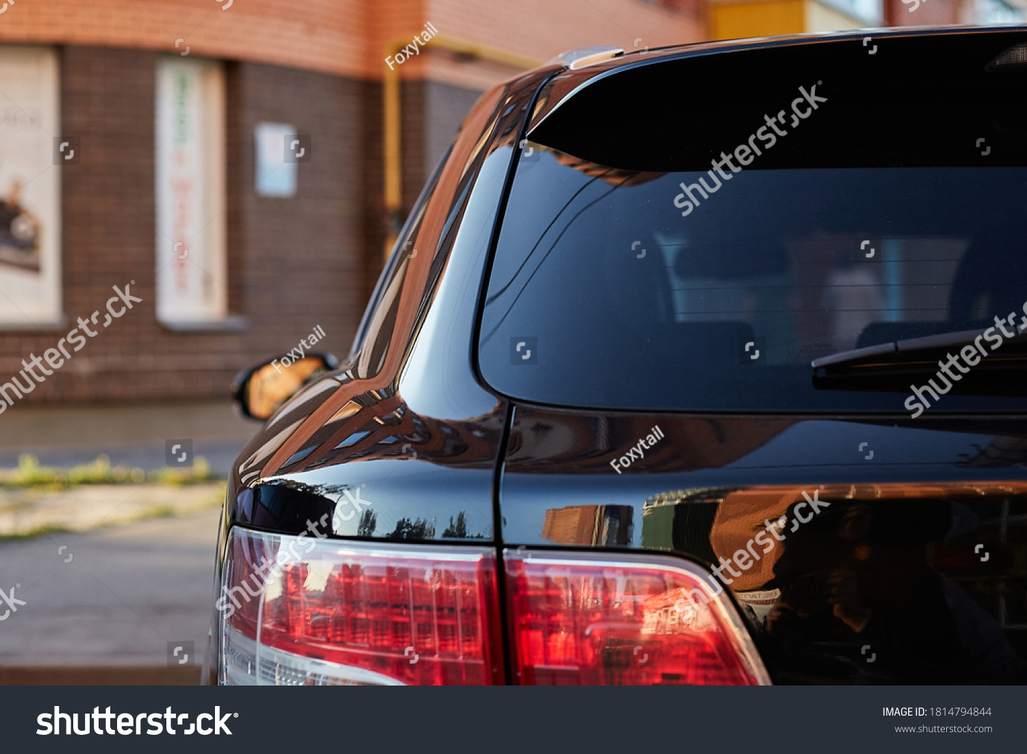 Back window of a car parked on the street in summer sunny day, rear view. Mock-up for sticker or decals #1814794844