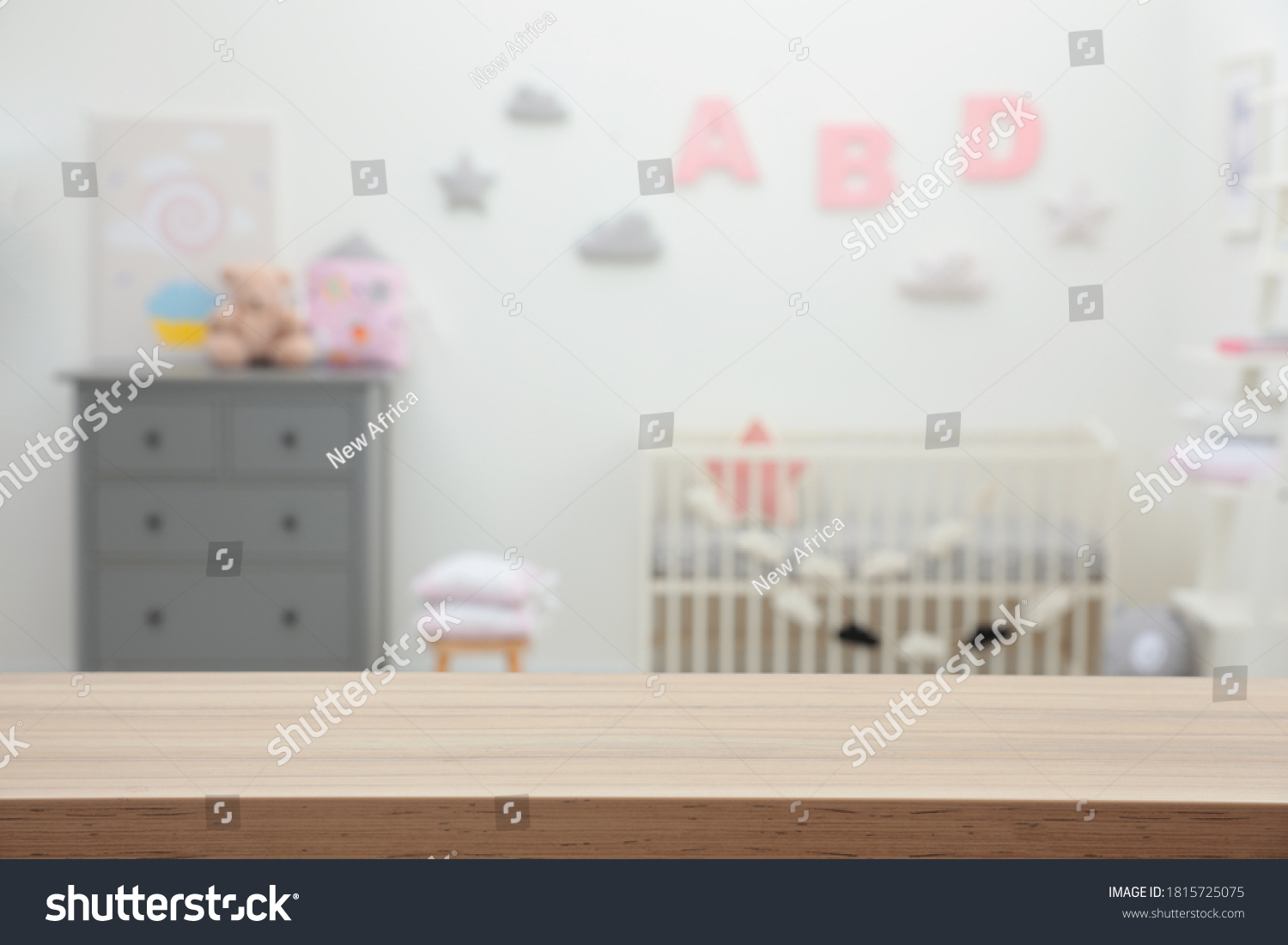 Empty wooden table in baby room. Space for text #1815725075