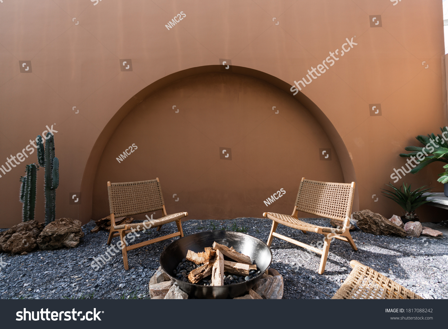 Minimal empty space scene with brown painted wall and  rattan armchair and artificial cactus with rock setting  in natural light scene / studio concept / tropical theme / outdoor studio #1817088242