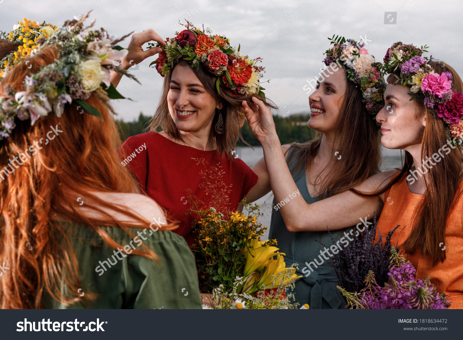 Lovely women's in flower wreaths in nature. Ancient pagan origin celebration concept. Summer solstice day. Mid summer. #1818634472