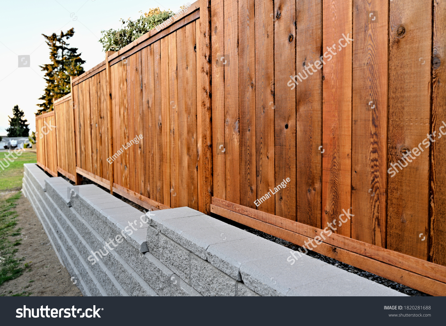 Staggered retaining block wall, cement blocks, new construction, wooden fence, panel fence,  residential property,  #1820281688