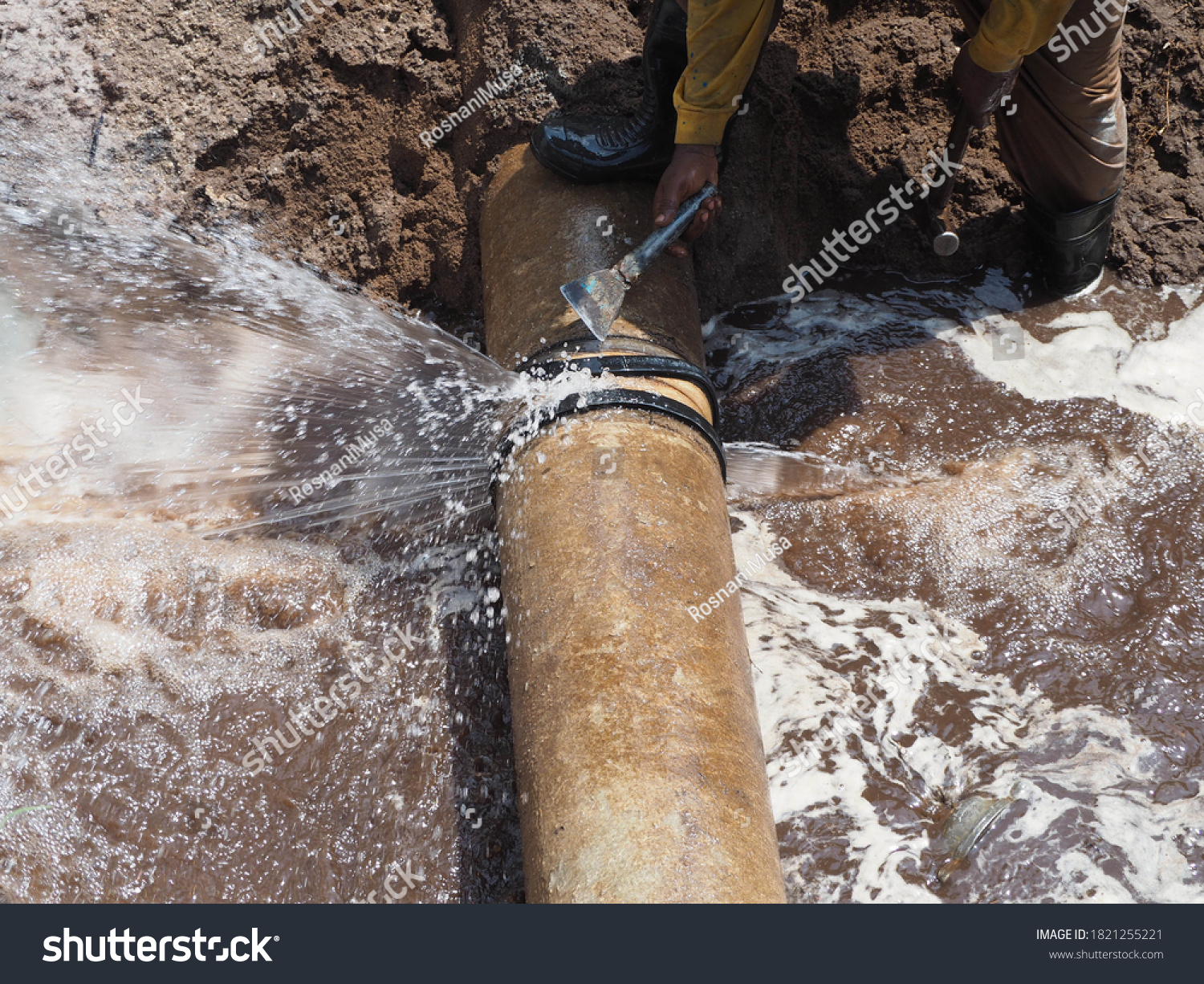 The main pipe is broken or burst and is being repaired #1821255221