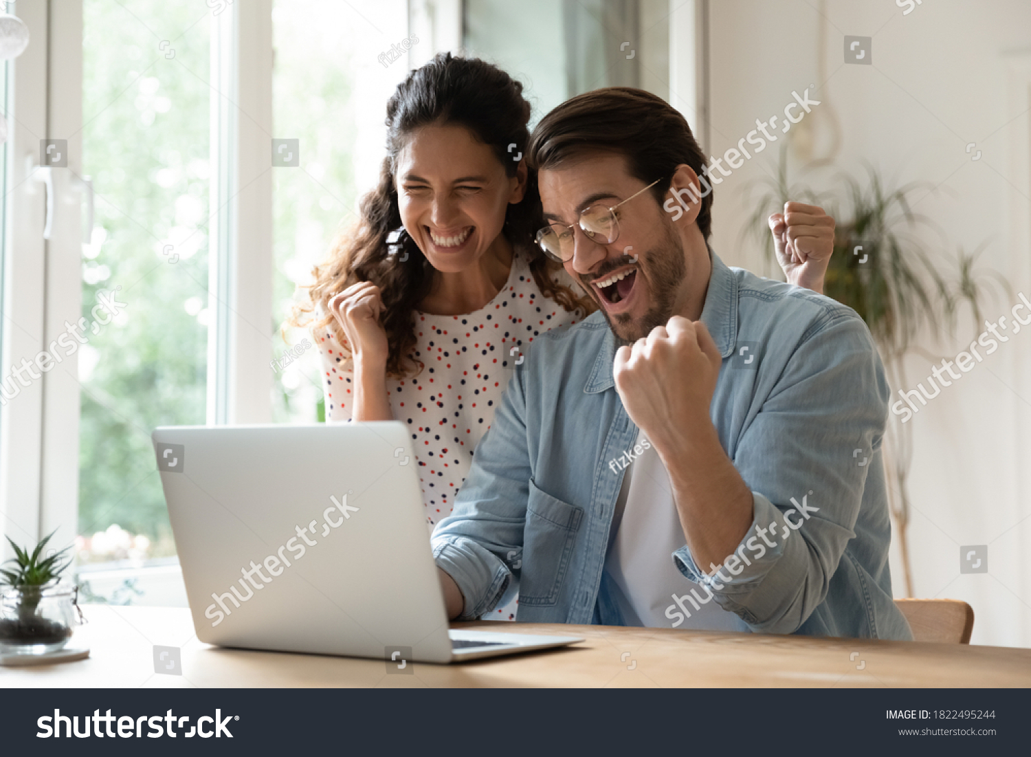 Overjoyed millennial man and woman triumph win online lottery on laptop. Happy excited young Caucasian couple feel euphoric with good email, get amazing sale offer or discount deal on computer. #1822495244