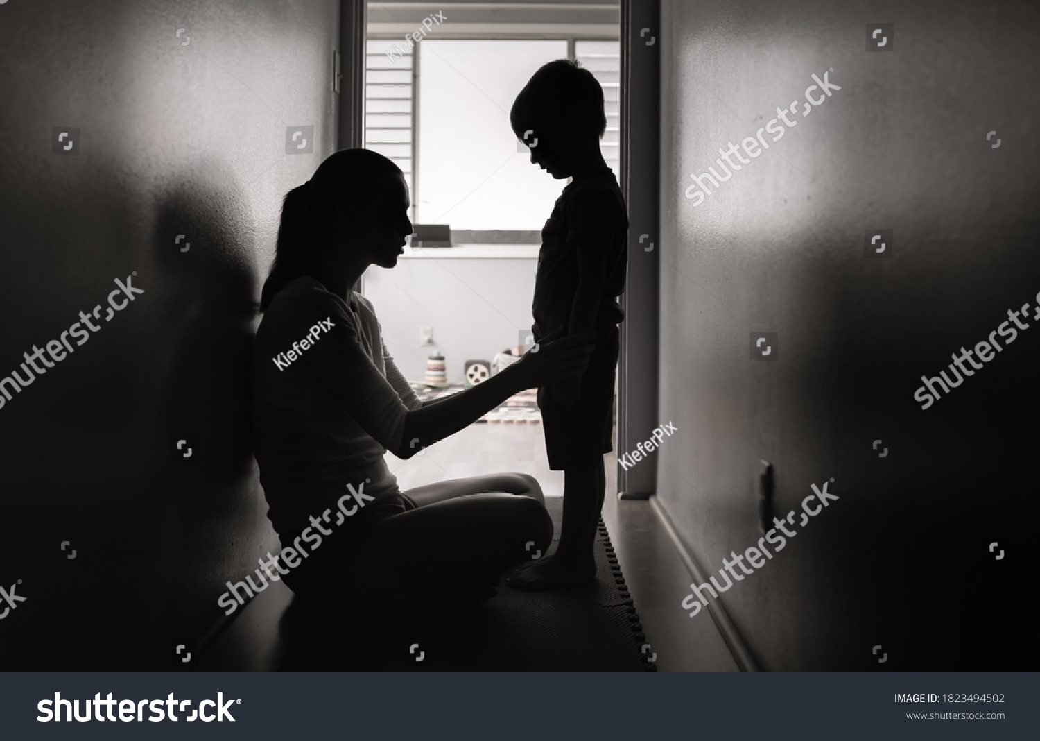Mother talking to her child at home. Correcting, and disciplining children concept.   #1823494502