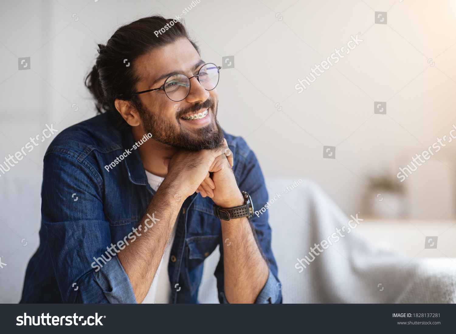 Portrait Of Smiling Indian Man With Eyeglasses And Braces In Home Interior, Handsome Pensive Western Guy Daydreaming And Looking Away, Thinking About Something, Selective Focus With Copy Space #1828137281