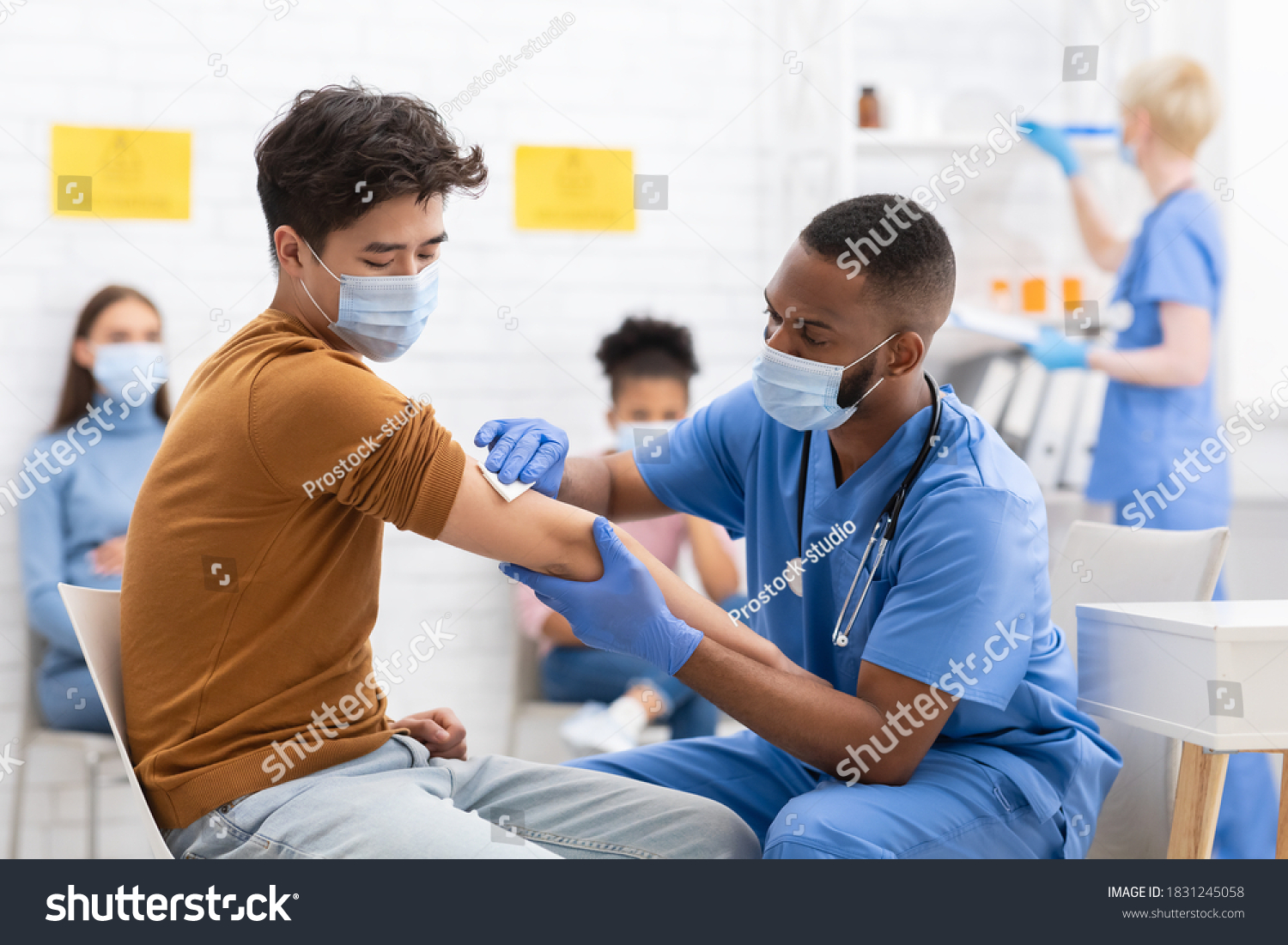 Covid-19 Vaccination. Asian Male Patient Getting Vaccinated Against Coronavirus Receiving Covid Vaccine Intramuscular Injection During Doctor's Appointment In Hospital. Corona Virus Immunization #1831245058