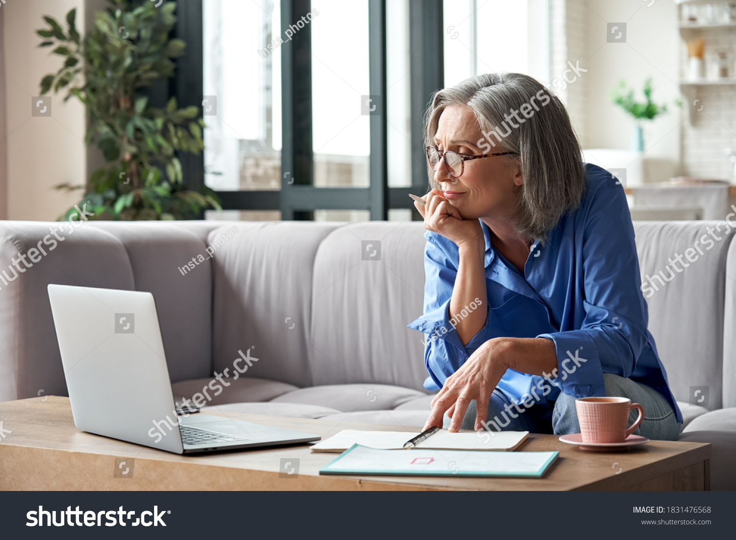 Senior mature older woman watching business training, online webinar on laptop computer remote working or social distance learning from home. 60s businesswoman video conference calling in virtual chat #1831476568