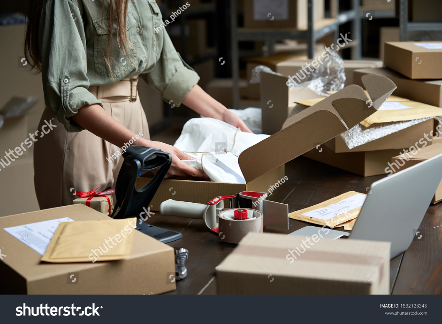 Closeup view of female online store small business owner seller entrepreneur packing package post shipping box preparing delivery parcel on table. Ecommerce dropshipping shipment service concept. #1832128345