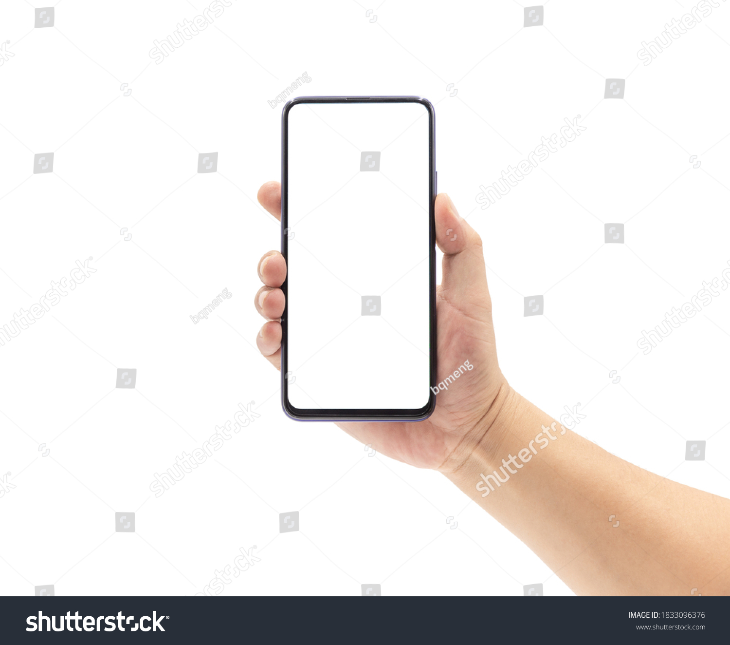 A man's hand holds a blank smartphone with a black frame. #1833096376