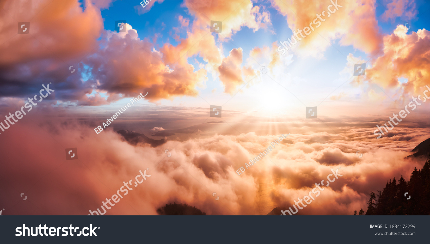 Beautiful Panoramic View of Canadian Mountain Landscape covered in clouds during a vibrant summer sunset. Dramatic Sky Artistic Render. St Mark's Summit, West Vancouver, British Columbia, Canada. #1834172299