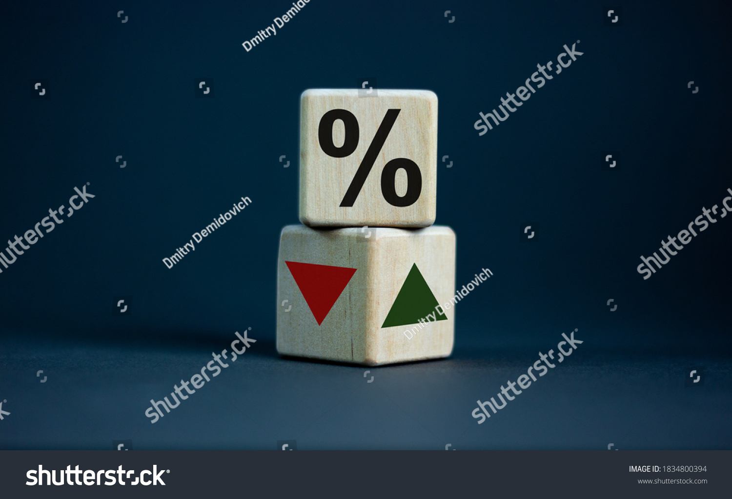 Wooden cubes changes the direction of an arrow symbolizing that the interest rates are going down or vice versa . Business concept. Copy space, beautiful grey background. #1834800394
