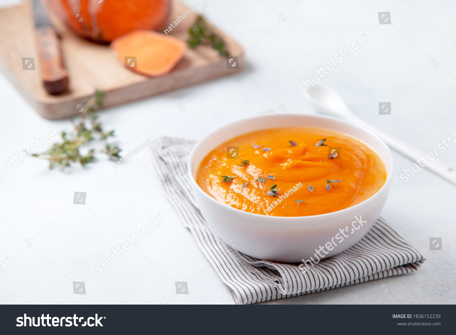 mashed sweet potatoes in a wooden bowl on a light background #1836152239