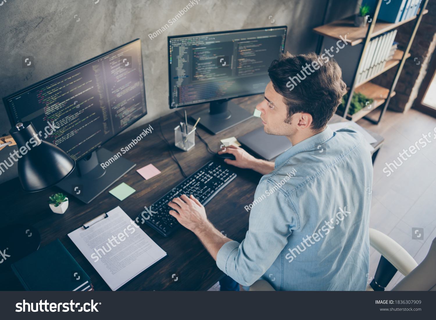 Top above high angle view portrait of his he nice attractive focused skilled geek guy typing bug track report cyberspace security at modern industrial interior style concrete wall work place station #1836307909
