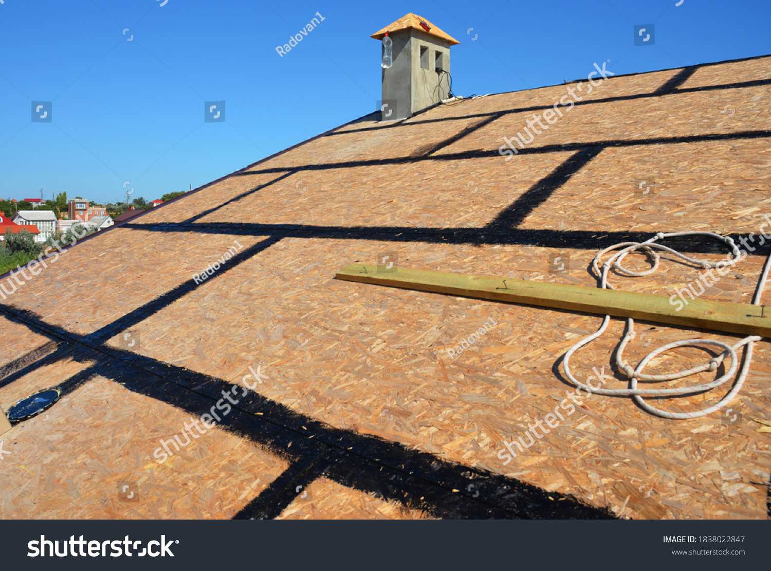 A close-up on an incomplete roofing construction on the stage of roof sheathing with self-adhering rubberized asphalt flexible flashings installed. #1838022847