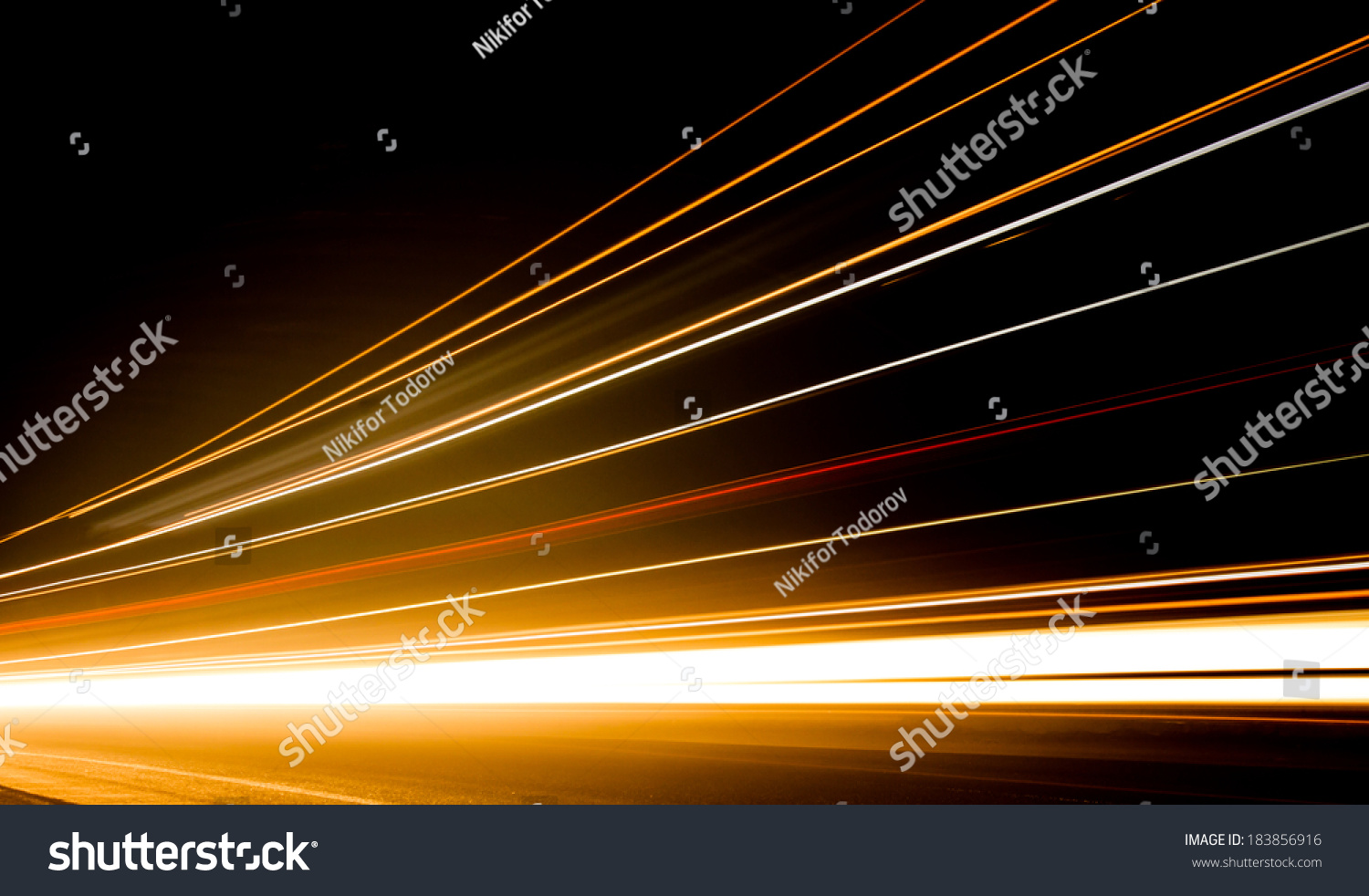 Truck light trails in tunnel. Art image . Long exposure photo taken in a tunnel  #183856916