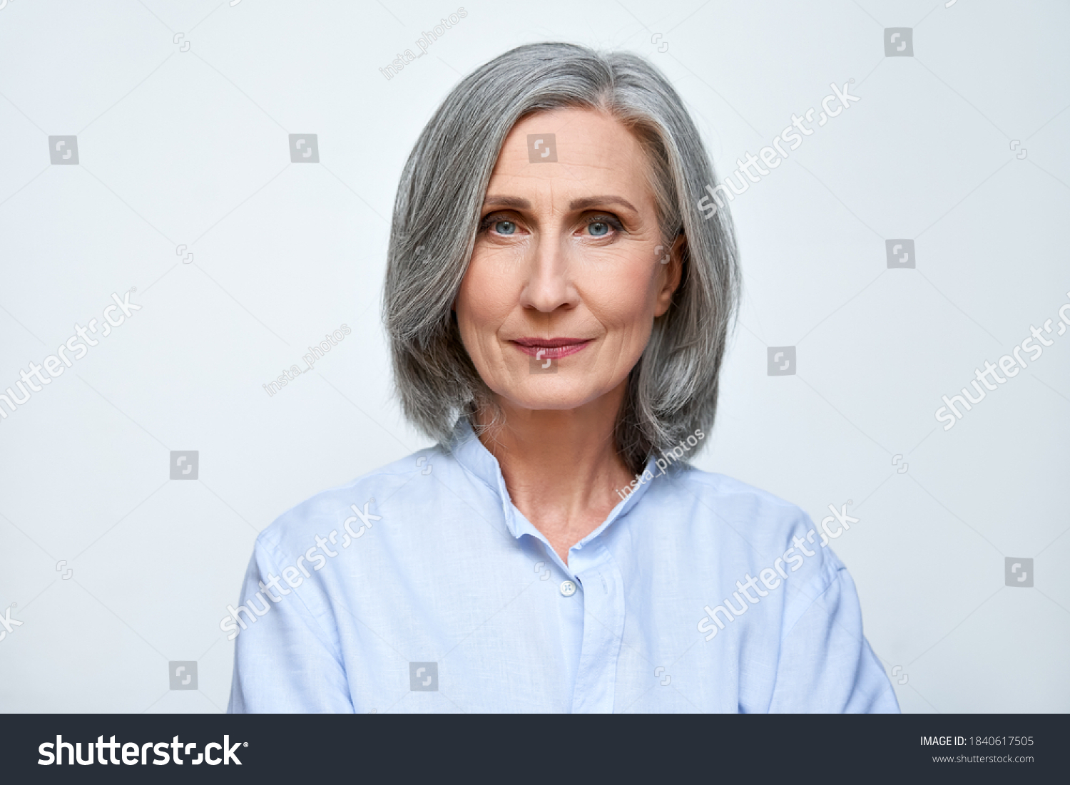Confident beautiful mature business woman standing isolated on white background. Older senior businesswoman, 60s grey haired lady professional looking at camera, close up face headshot portrait. #1840617505