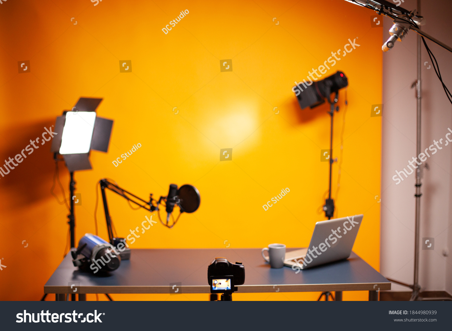 Professional podcast and vlogging setup in studio with yellow background. #1844980939